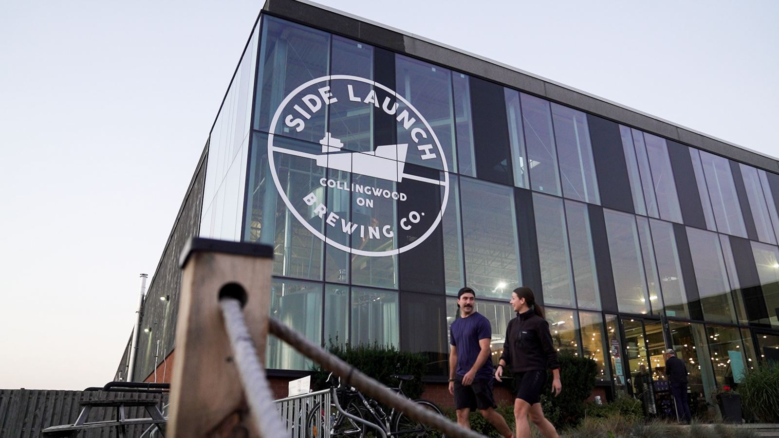 Riders walking past Side Launch Brewing in Collingwood