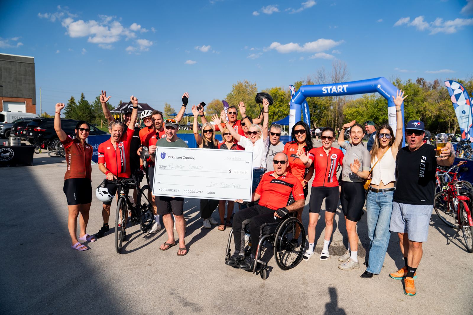 Les Domestiques team presenting a $166,308 cheque to Parkinson Canada