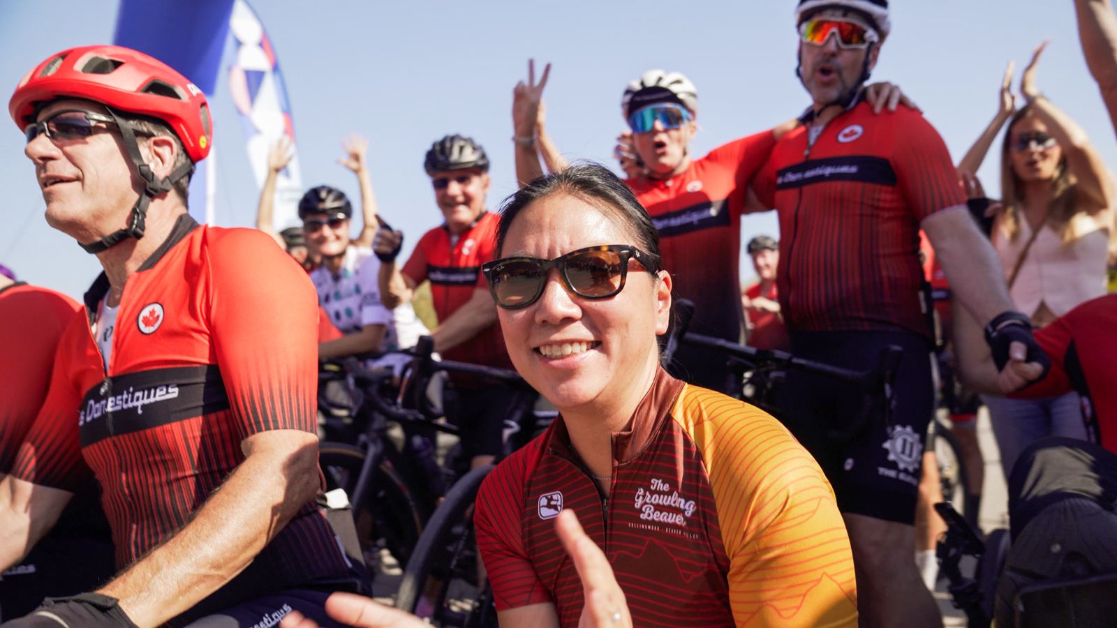 Smiling rider in a Growling Beaver jersey with her team