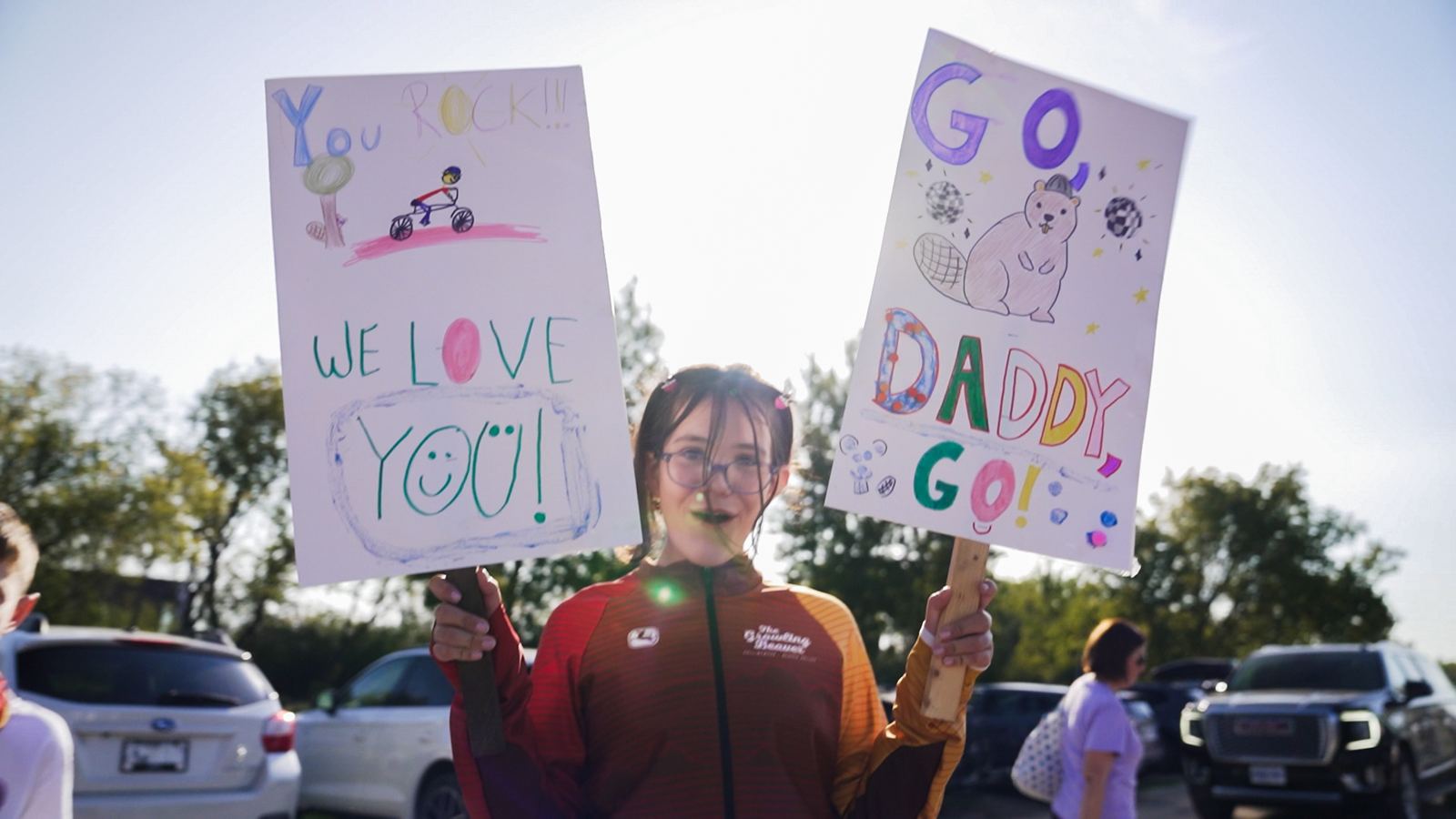 Young supporter holding Go Daddy Go and We Love You signs
