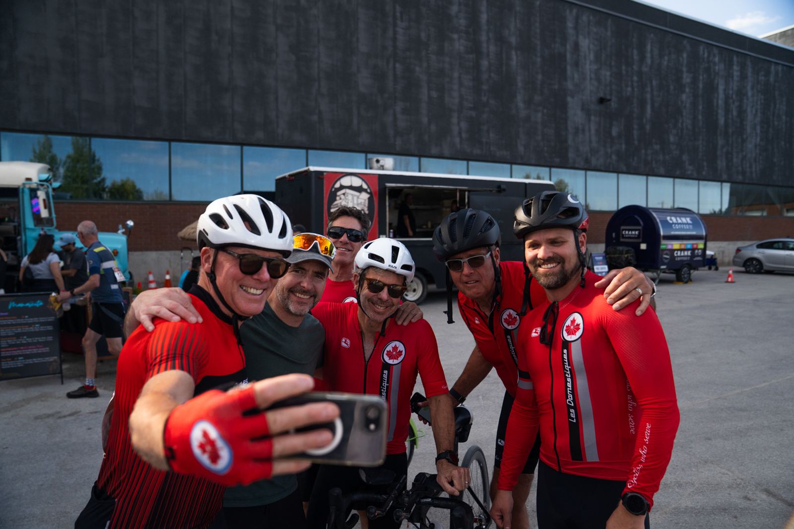 Team of riders taking a selfie by the food trucks