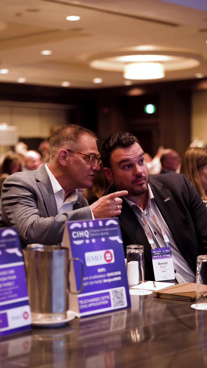 Two attendees in conversation at a CIHQ table